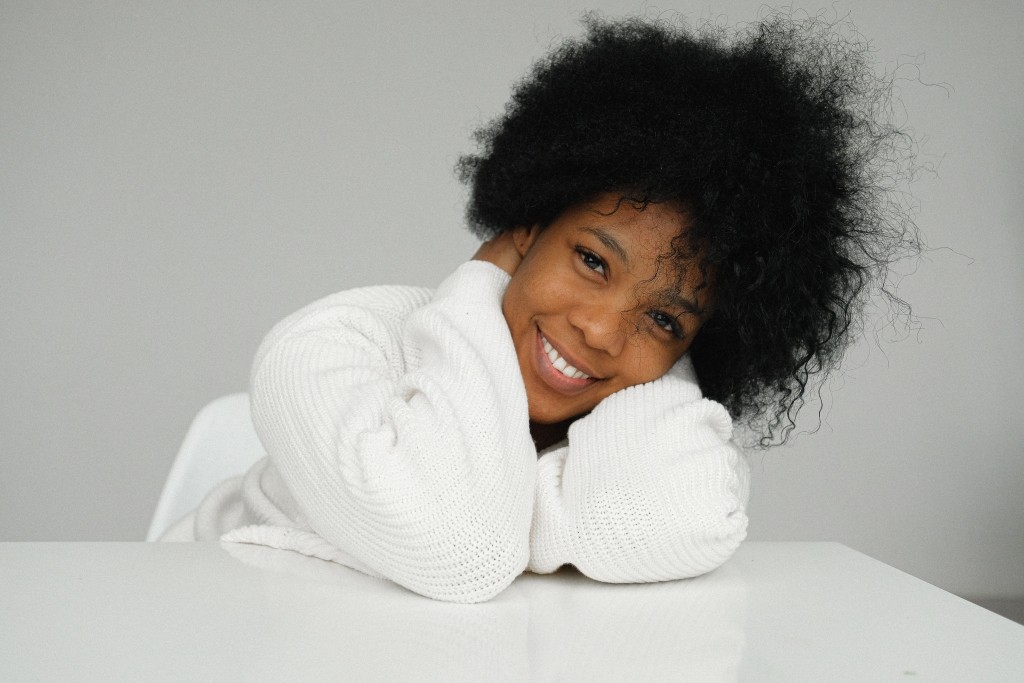 Woman in white sweater smiling